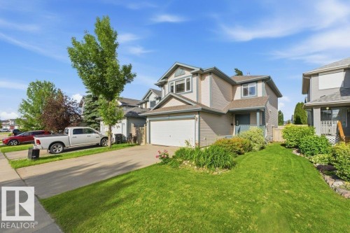 Two-story residence with light-colored siding and an attached garage - 2811 33 Street, Edmonton, AB 