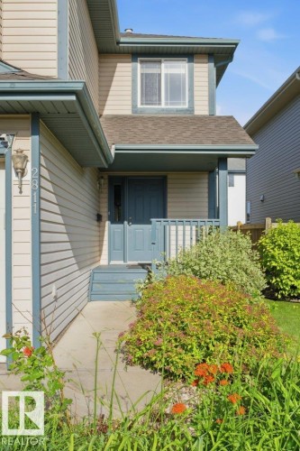Property exterior featuring horizontal siding, a covered entry porch, and a second-story window - 2811 33 Street, Edmonton, AB 