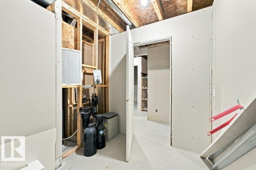 Unfinished interior space featuring exposed ceiling joists, drywall installation in progress, and visible utility systems - 2811 33 Street, Edmonton, AB 