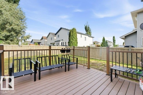 Spacious rear deck featuring composite decking, dark metal railings, and wood-finish posts - 2811 33 Street, Edmonton, AB 
