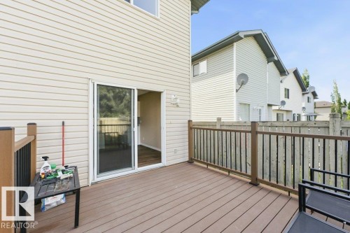 Spacious outdoor deck featuring composite decking, dark railings, and a sliding glass door for interior access - 2811 33 Street, Edmonton, AB 