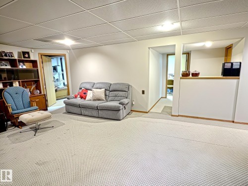 Carpeted room featuring a drop ceiling with recessed lighting - 171 Rhatigan Road, Edmonton, AB 