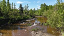 Natural waterway featuring a gentle current and earthen banks - 