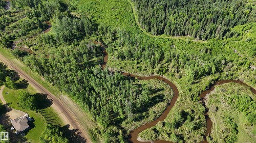 Expansive property featuring dense forest, winding river, and a residential structure with a gabled roof - 222A Range Rd, Rural Athabasca County, AB 