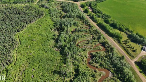 Aerial perspective showcasing a meandering river bordered by dense forest - 222A Range Rd, Rural Athabasca County, AB 