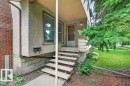 Front exterior with textured stucco siding and brick chimney - 9026 92 Street Nw, Edmonton, AB  - Outdoor 