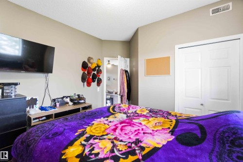 Neutral-toned walls complement the textured ceiling - 24 6520 2 Avenue, Edmonton, AB 