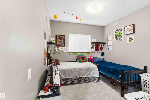 Carpeted room with neutral gray walls and a single window with blinds - 24 6520 2 Avenue, Edmonton, AB 