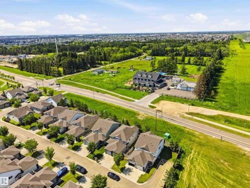 Residential neighborhood featuring detached properties with attached garages and paved driveways - 24 6520 2 Avenue, Edmonton, AB 