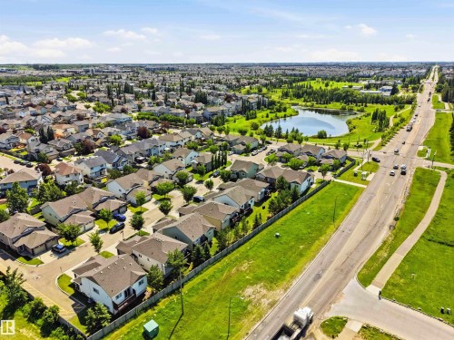 Aerial view of a residential community featuring numerous detached homes with pitched roofs and manicured lawns - 24 6520 2 Avenue, Edmonton, AB 