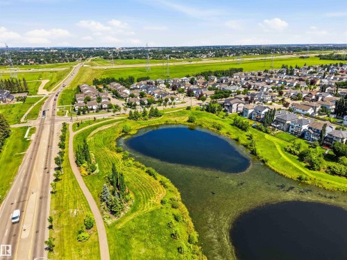 Expansive aerial view showcasing a residential development bordering a substantial roadway - 24 6520 2 Avenue, Edmonton, AB 