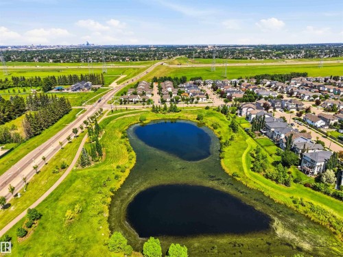 Aerial perspective showcasing a residential community with abundant green spaces - 24 6520 2 Avenue, Edmonton, AB 