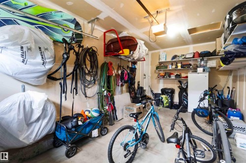 Spacious garage featuring concrete flooring and exposed ceiling joists - 24 6520 2 Avenue, Edmonton, AB 