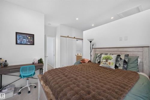 Neutral bedroom featuring recessed lighting and light-toned flooring - 8551 81 Avenue, Edmonton, AB 