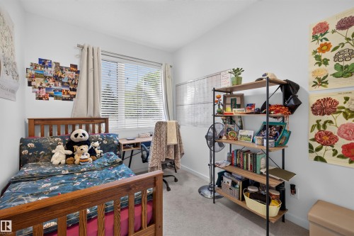 Room featuring a large window with blinds, light-colored carpeting, and a built-in wall-mounted whiteboard - 8551 81 Avenue, Edmonton, AB 