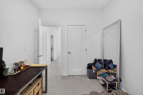 Hallway with light gray carpet flooring and white walls - 8551 81 Avenue, Edmonton, AB 