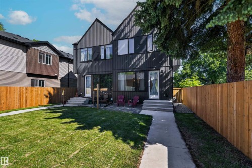 Modern exterior featuring vertical black siding and a pitched roofline - 8551 81 Avenue, Edmonton, AB 