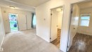 Carpeted entryway with a flush mount light fixture - 9359 92 Street, Edmonton, AB 