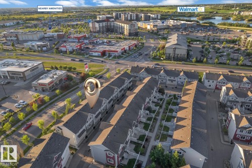 Aerial perspective of a multi-unit residential development featuring traditional architecture - 140 655 Tamarack Road, Edmonton, AB 