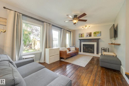 4810 42 Street, Beaumont, AB - Indoor Photo Showing Living Room With Fireplace