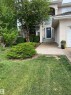 Stucco exterior with a dark blue front door and arched transom window - 1417 115A Street, Edmonton, AB  - Outdoor 