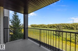 Covered balcony featuring a concrete floor and black metal railing - 