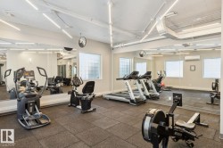 Fitness center featuring full-height mirrored walls and recessed lighting - 