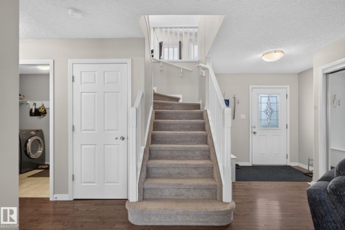 Carpeted staircase with white railings - 7858 170A Avenue, Edmonton, AB 