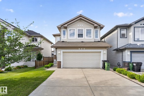 Two-story residential exterior featuring light-colored siding and a contrasting brown roof - 7858 170A Avenue, Edmonton, AB 