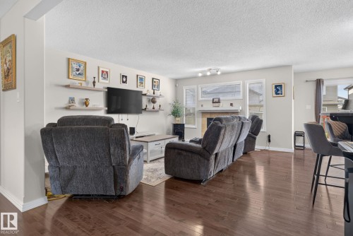 Spacious living area featuring rich wood-finish flooring - 7858 170A Avenue, Edmonton, AB 