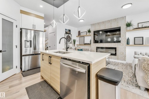 3807 40 Avenue, Beaumont, AB - Indoor Photo Showing Kitchen With Fireplace With Double Sink With Upgraded Kitchen