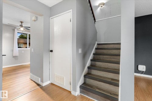 Interior staircase with wood-finish treads and risers, complemented by light wood-finish flooring - Fort Saskatchewan, AB 