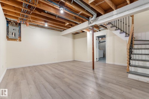 Finished basement space featuring light wood-finish flooring, recessed lighting, and painted walls - Fort Saskatchewan, AB 