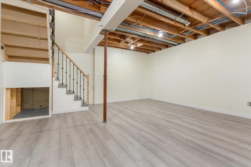 Open basement area featuring light wood-finish flooring - Fort Saskatchewan, AB 