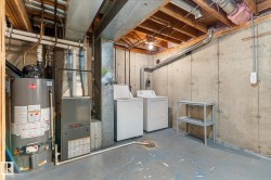 Utility area featuring a water heater, furnace, and exposed ceiling joists - 