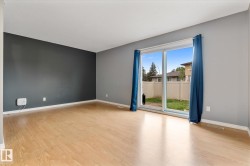 Spacious room featuring light wood-finish flooring and a sliding glass patio door - 