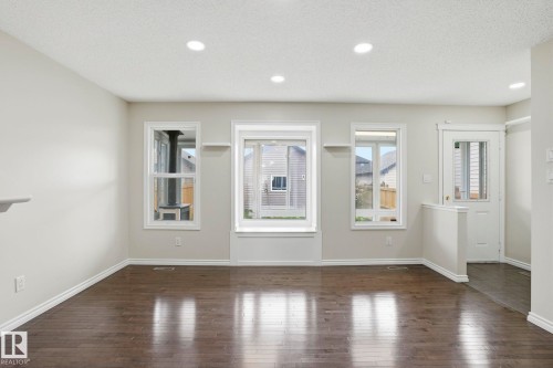 Living area featuring dark wood-finish flooring and light-toned walls - 445 Watt Boulevard, Edmonton, AB 