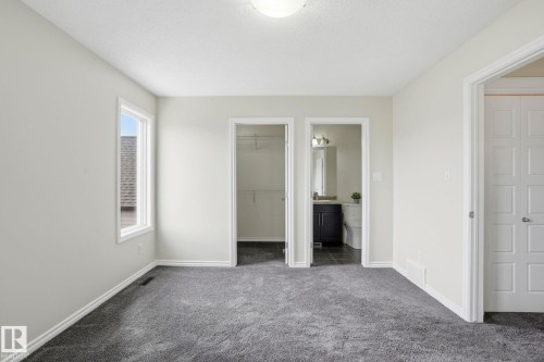 Spacious room featuring neutral paint, gray carpeting, a single window, and a flush mount ceiling light - 445 Watt Boulevard, Edmonton, AB 