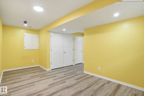 Room with wood-finish flooring, recessed lighting, and bright yellow wall paint - 445 Watt Boulevard, Edmonton, AB 