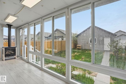 Sunroom featuring extensive window panels and light wood-finish flooring - 445 Watt Boulevard, Edmonton, AB 