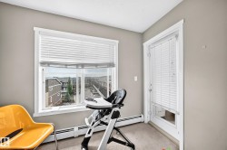 Room featuring neutral wall paint, white trim, and a window with horizontal blinds - 