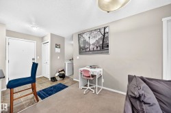 Entry area with tile flooring opening to a carpeted living space - 