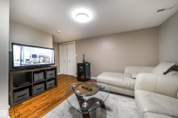 Neutral-toned walls complement the warm wood-finish flooring - 