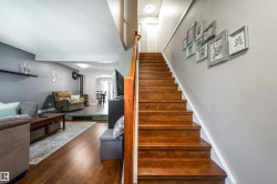 Hardwood stairs with a light wood railing complement the wood-finish flooring - 