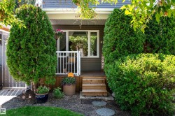 Front entry with wood siding and white trim windows - 