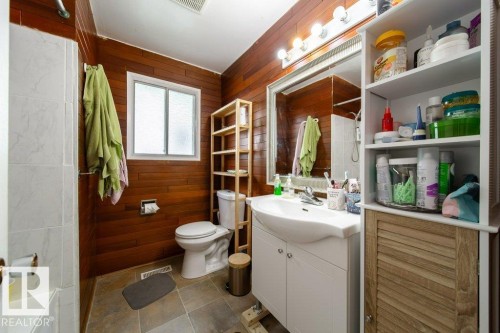 Bathroom featuring wood-finish paneling and tile flooring - 4224 89 Street, Edmonton, AB 