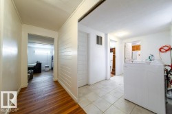 Utility area featuring light tile flooring and a white painted interior - 