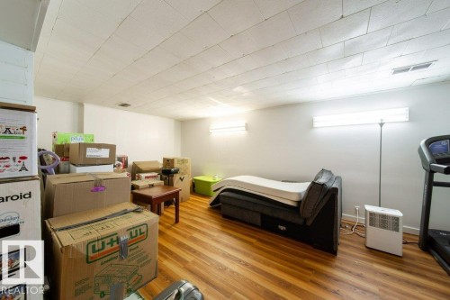 Finished room featuring wood-finish flooring, white walls, and a white ceiling - 4224 89 Street, Edmonton, AB 