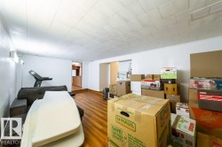 Spacious interior featuring wood-finish flooring, white walls, and a recessed ceiling - 
