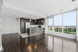 Expansive open concept living area featuring dark wood-finish flooring - 